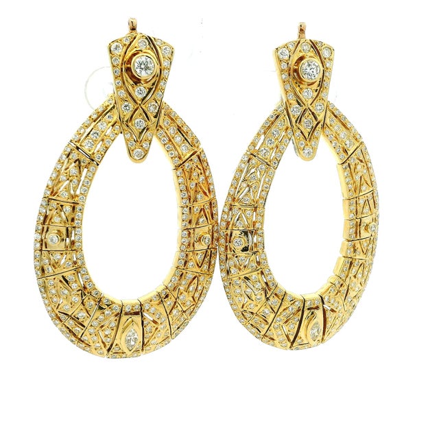 Exceptional vintage American statement earrings crafted in 18K yellow gold and set with approximately 5.00 carats of...