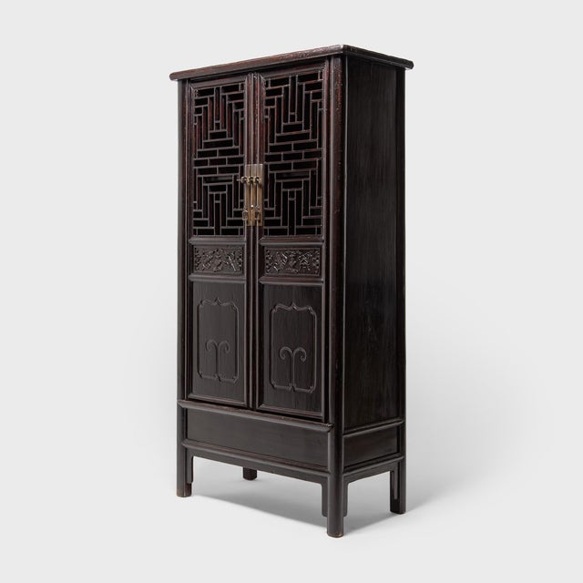The focal point of this beautiful 19th-century scholars' display cabinet is undoubtedly the complex diamond-form lattice...