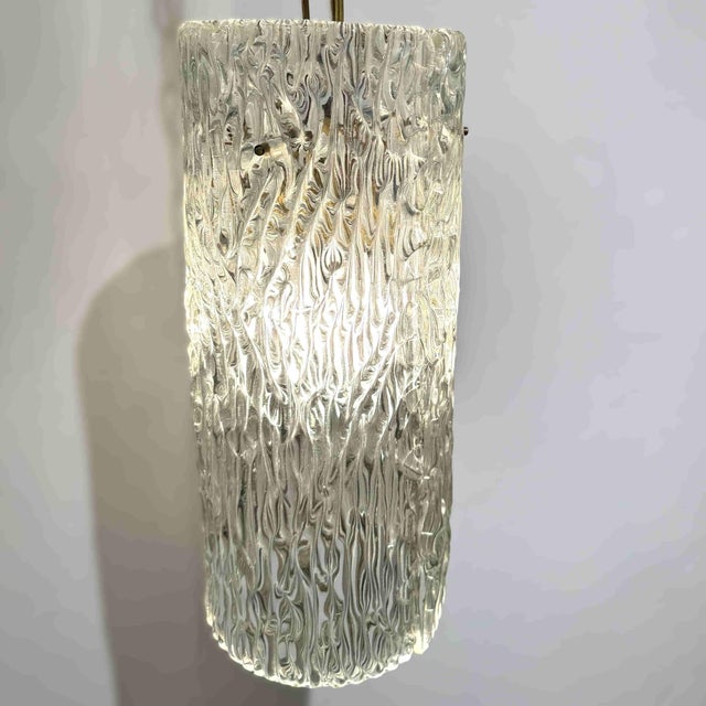 An Orrefors designed modernist crystal lantern. Textured crystal with patinated brass details.