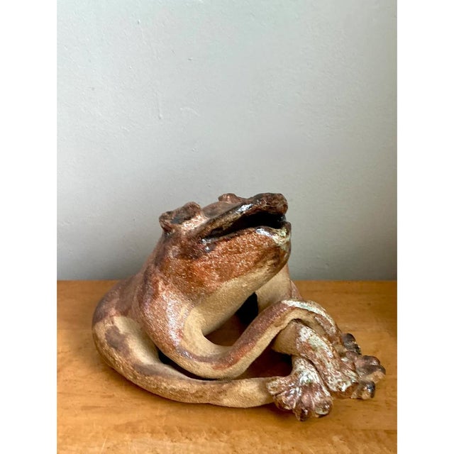 This vintage ceramic frog sculpture brings a whimsical, naturalistic presence to a room. Its rounded body and intertwined...