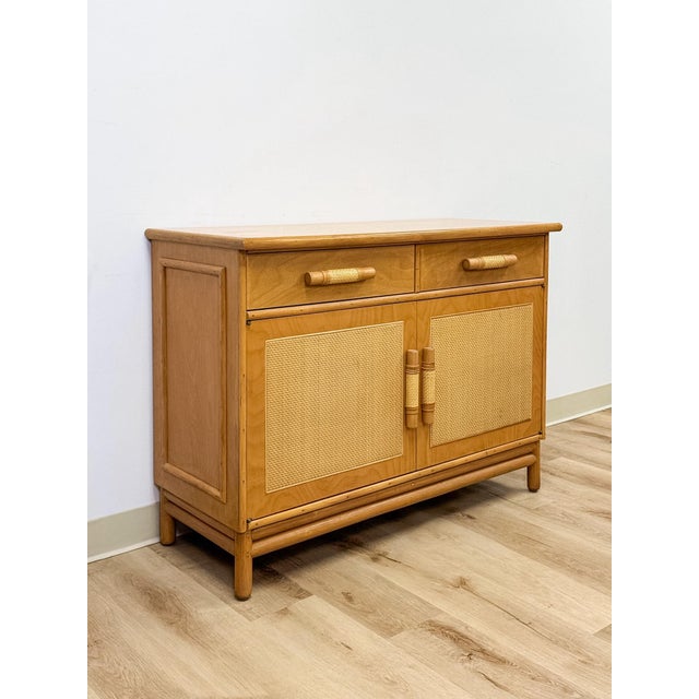 This vintage rattan and wicker cane buffet brings an easy, coastal sensibility to any dining room or living space,...