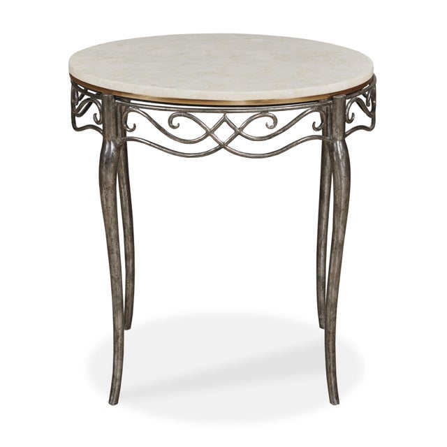 Elegant and poised, this round side table pairs a veined marble top with a hand-carved apron of interlacing scrollwork....