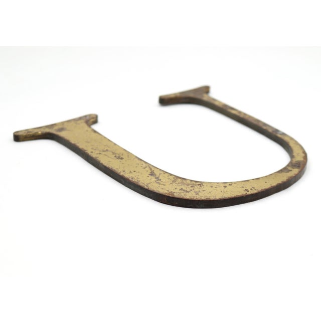 Vintage roman serif style letter U sign made of brass with a brushed finish. The piece is flat on the back. Good condition...