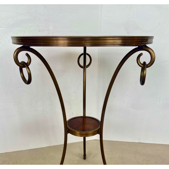 This is a charming and very useful French metal Bronze Color 2 Tier Gueridon table with Marquetry Wood, at the top and...