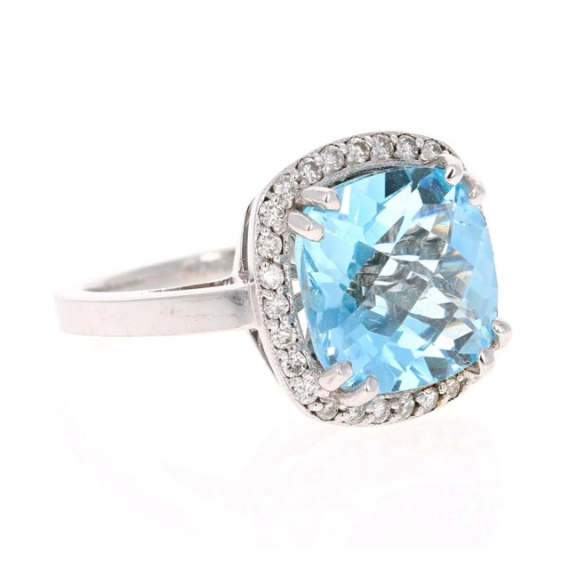 This incredible Square Cushion Cut Blue Topaz and Diamond ring has a stunning and large 8.94 Carat Blue Topaz and its...
