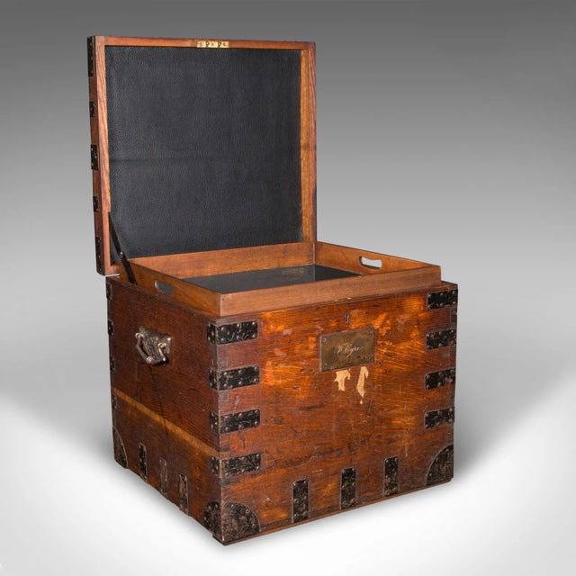 This is an antique fitted silver chest. An English, oak and bound iron shipping trunk, dating to the late Victorian...