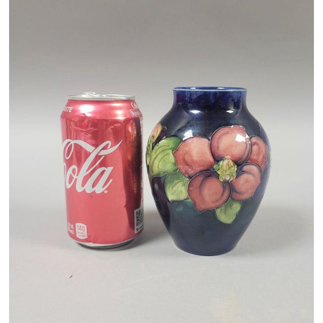 Vintage Walter Moorcroft Clematis art pottery vase, hand decorated with tube-lined pink, plum and purple flowers and green...