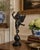 A beautifully modeled late 20th-century winged putto sculpture by Decorative Crafts, rendered in metal with a deep bronze...