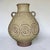 A large West German ceramic amphora vase dating to the 1970s, featuring a warm sand-toned glaze and a band of raised...
