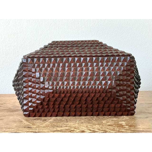 Discover the rustic charm and intricate craftsmanship of this vintage Tramp Art wooden box. A quintessential example of...