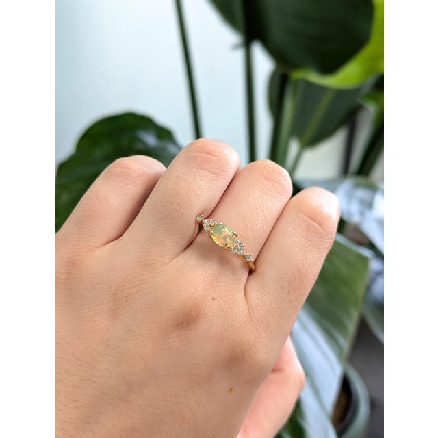 This lovely opal has all the colors of the rainbow, accented with natural earth mined diamond accents, all set in solid...