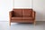 An elegant, brown leather two-seater sofa, manufactured by Mogens Hansen, Stouby with a pleasing beech frame and quality...