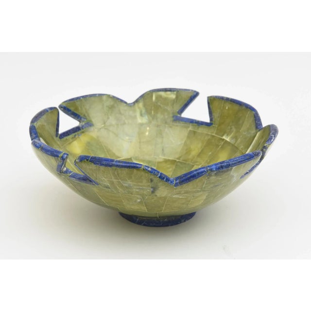 This special bowl is a beautiful combination of green stone with lapis center and outlines. The sculptural shape of the...
