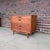 Jens Risom Mid-Century Modern walnut cabinet featuring beautifully figured walnut and sculpted wood pulls. The cabinet...
