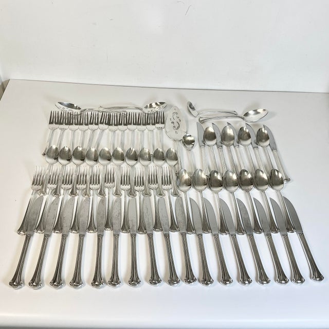 Vintage Home is pleased to offer this 1970s Vintage set of Silver Plate Flatware. It features a lovely flared tip end. We...