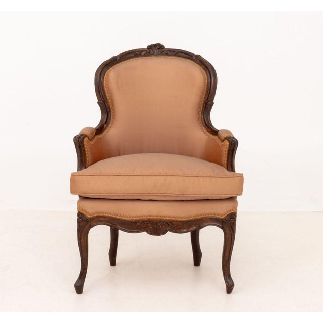 Louis XV Silk Upholstered Walnut Children's Bergere, the frame carved with floral motifs. 26.5" H x 19" W x 15" D; seat:...
