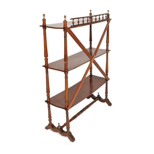 This neo-classical bookcase was produced by Fratelli Mora Milano. It is made of walnut which has been polished to wax.