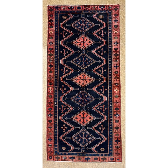 Antique hand-knotted runner from the Hamedan region of western Iran, featuring a repeating series of diamond-shaped...