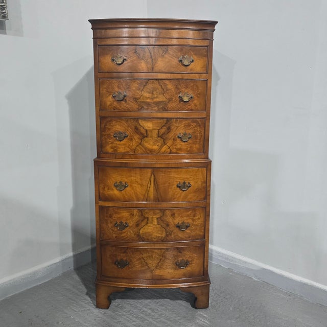 Excellent honey coloured small sized bowed Queen Anne style chest on chest of six drawers with brass handles, standing on...