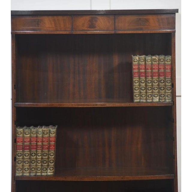 ine quality antique mahogany open bookcase, dating from the early 20th century. Of elegant design, it features four...