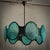 A charming chandelier with a round shape, like a giant bracelet hanging from the ceiling, featuring large Murano glass...