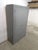 Curved wooden workshop locker, repainted in gray Curved wooden locker. Two-door wooden locker. The wood was originally...