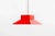 The lamp features a red enameled metal shade that hangs on four chords from a red ceiling fixture in the same material....