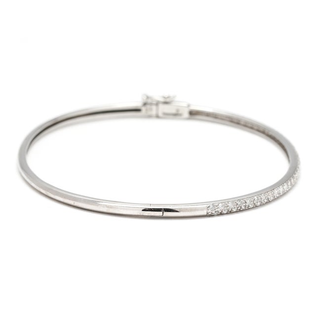 Stones: diamond, 76 round brilliant cut 1.1 mm approximately .40 total carats HI color/ SI1-I1 clarity Circumference: 6.75...