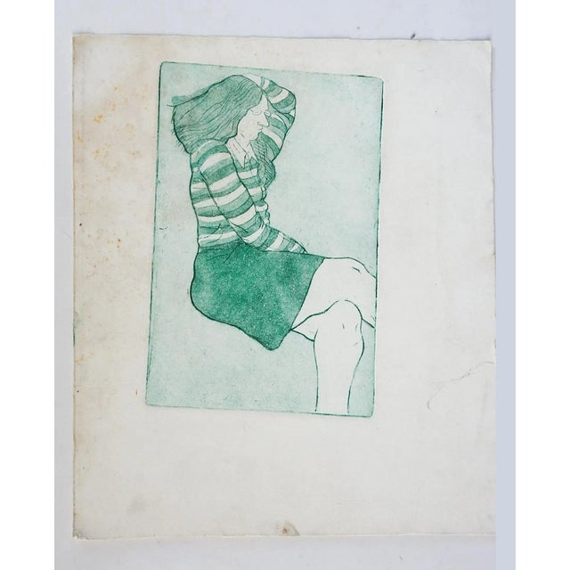 Colored etching on paper in green of seated woman. Unsigned. Unframed, image size 6" x 9", etching crooked on sheet, edge...