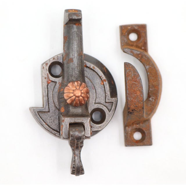 Antique window lock made of black finished cast iron with a copper finished brass floral button. The original mounting...