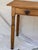 This attractive and timeless English pine side table has a rectangular shape, raised on four turned legs, and has 1 lovely...
