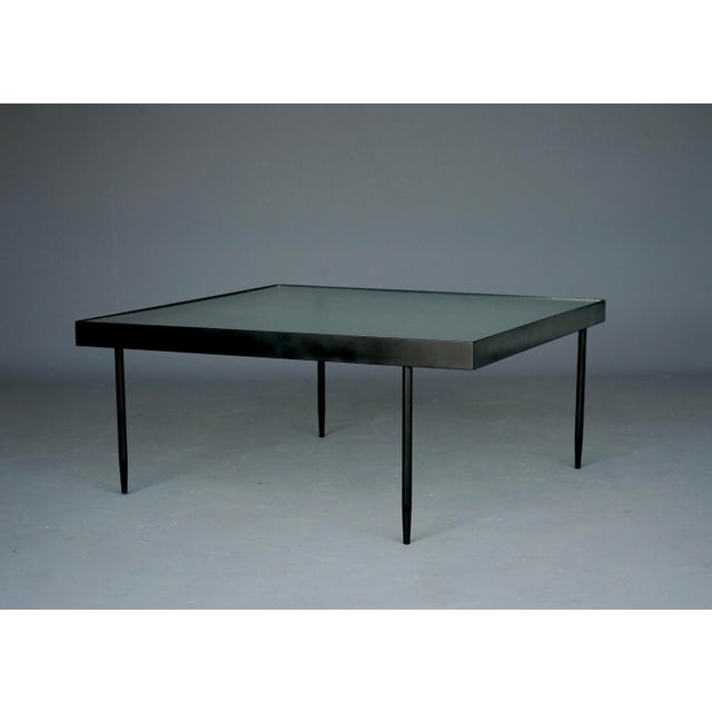 Rare minimalist coffee table designed by Janni van Pelt. This is model G4A. Black painted metal frame and turned metal...