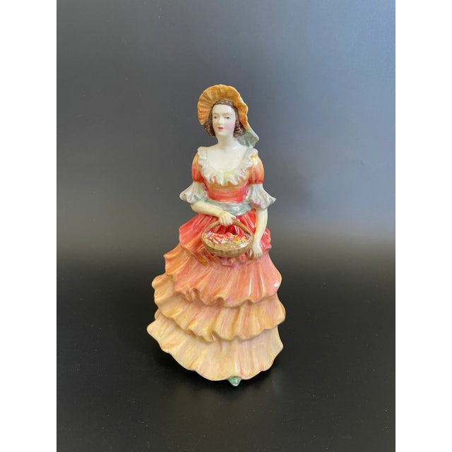 A vintage Paragon fine bone china hand painted figurine titled "Helen", featuring a Georgian-era lady dressed in orange...