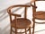 A set of two antique chairs in bentwood, with a curved crest rail over vertical splats and a moulded board seat....