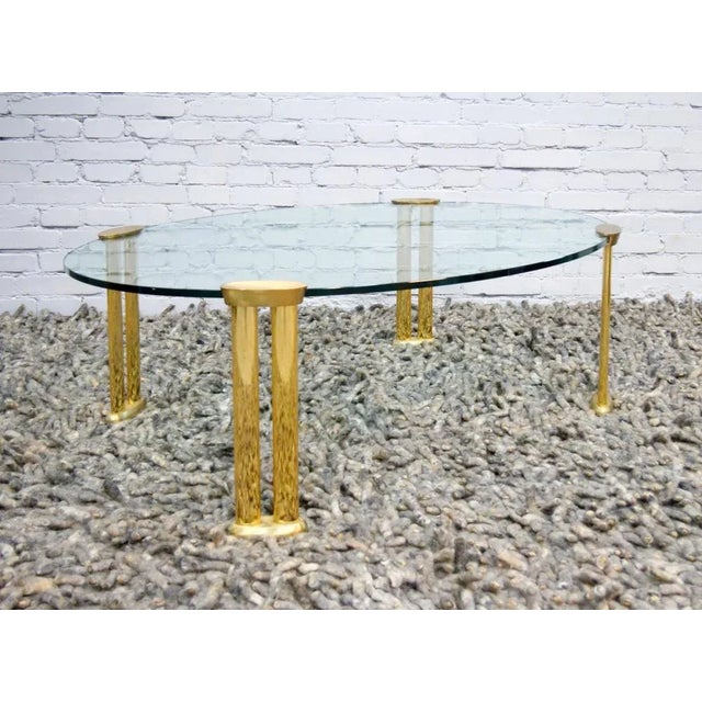 Italian, unique oval brass and glass table, early seventies. Thick glass, legs are solid brass with a beautiful patina,...