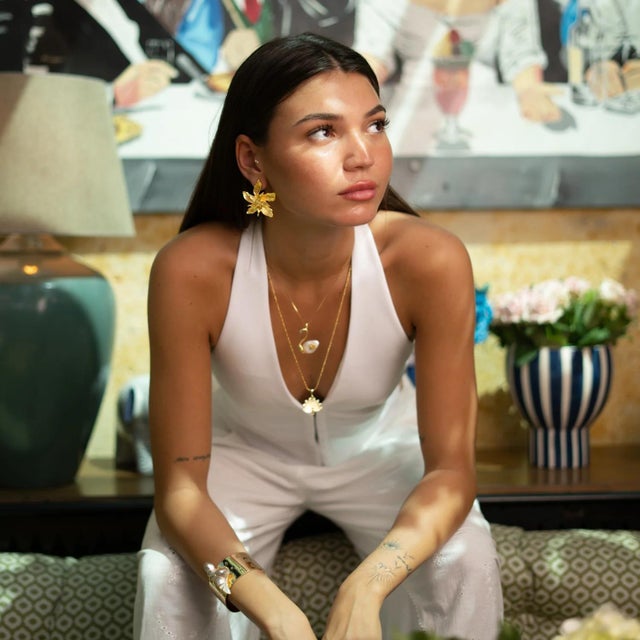 Bring a touch of timeless elegance to your style with the Floral Majesty Gold Stud Earrings. Handcrafted from bronze and...