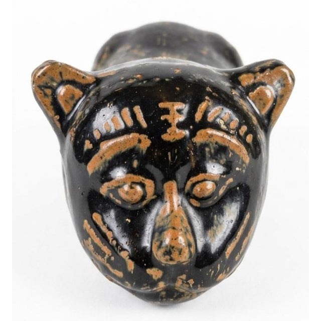 It was a porcelain pillow, molded in the shape of a crouching beast, meant to support the neck during long nights of study...