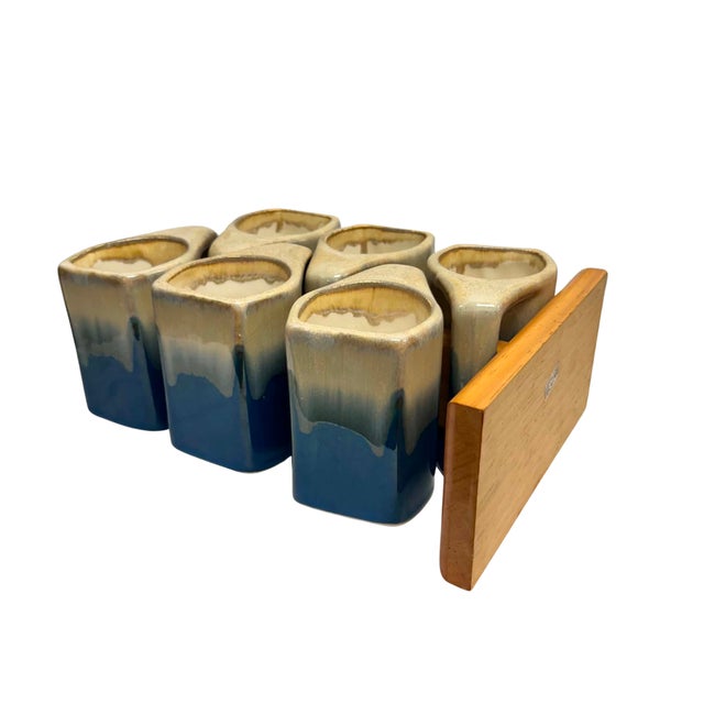 A complete vintage Padilla stoneware beverage set featuring six handled mugs, the original wooden mug carousel, matching...