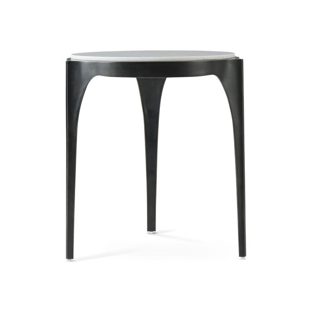 Side Table is the ideal piece to accompany your relaxation. The raised marble top is set upon an organic three-legged...
