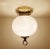 Vintage Limburg flush light, featuring globe glass shade mounted on a brass base with ring finial. Very good condition....