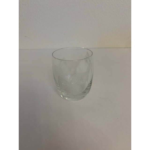 From the 1930's this "Tumble up" bedside carafe and glass from Anchor Hocking Company and has an etched marking of bows on...