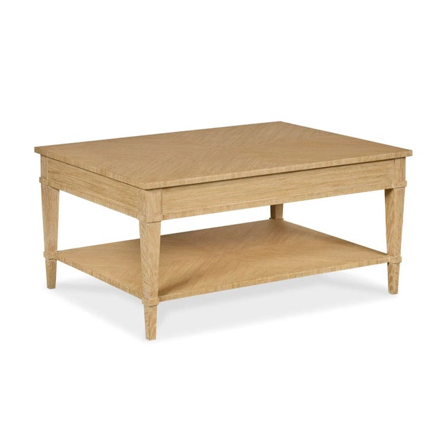 Traditional form meets modern finish in this light cerused oak cocktail table. Custom octagonal hardware is made of brass...