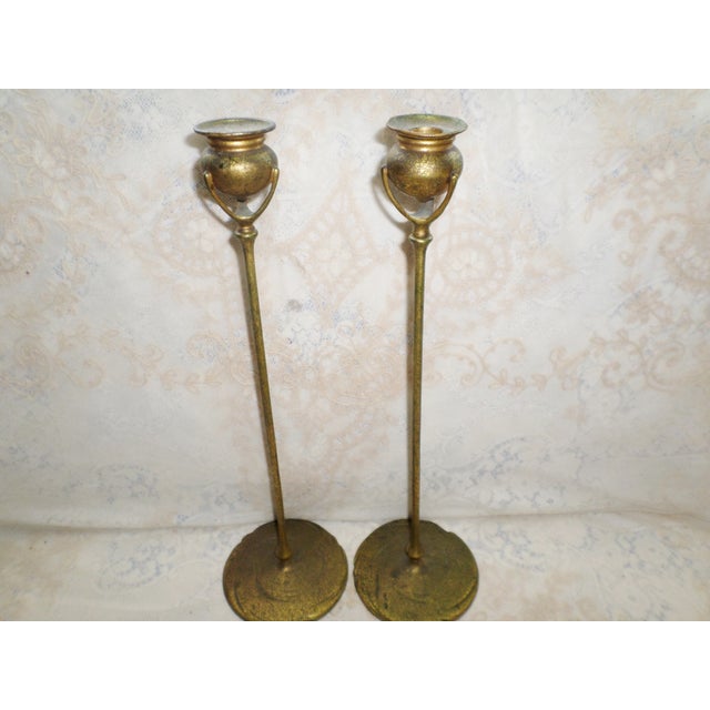This is an elegant pair of antique Tiffany Studios art nouveau bronze and gold gilt candlesticks. The Tiffany Candlesticks...