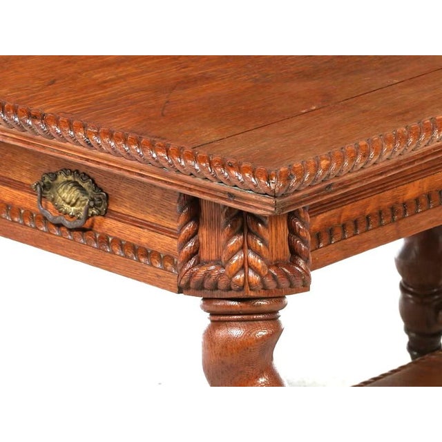 Made by Merklen Brothers of NYC, c. 1983. This antique library table is crafted from oak, characteristic of the late 19th...