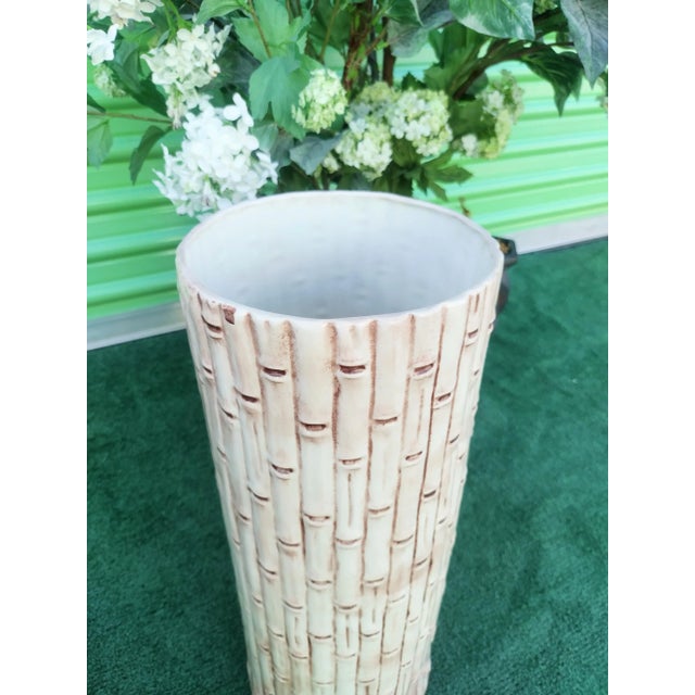 A beautiful vintage faux bamboo umbrella stand holder. The holder features a faux bamboo design in off white with brown...