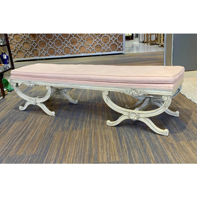 Oversized double curule tufted bench in the Hollywood Regency style. Shell detailing. Original upholstery is in very good...