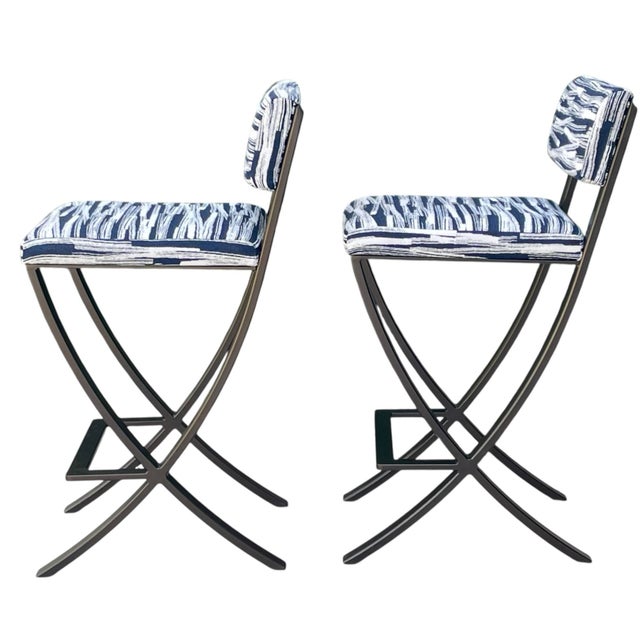 A striking pair of sculptural forged steel counter stools in the style of the Charleston Forge Naples design. Each stool...