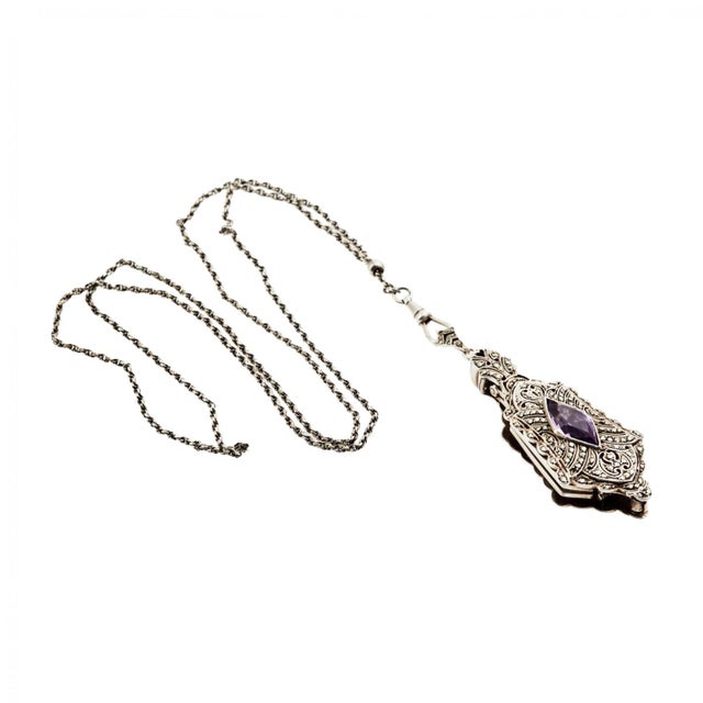 Corsage lorgnette pendant on a chain. The folding lorgnette is hidden in a shield-shaped pendant with a diamond-shaped...