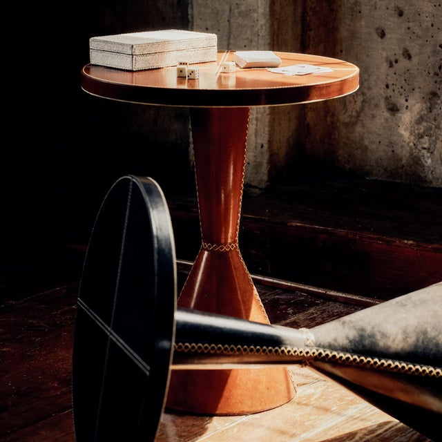 Craftsmanship meets modern design with the Gabe Leather Accent Table. Wrapped in rich leather with intricate stitching, it...