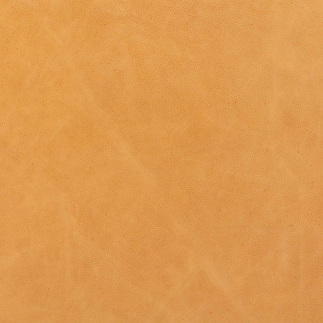 Upholstered in rich top-grain leather with a visible grain and paired with a subtly distressed parawood base, this large,...